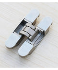 Zinc Alloy Concealed Hinge With 3D Adjustable Alignment for Cabinets And Doors, Smooth Invisible Hinge on a wooden surface