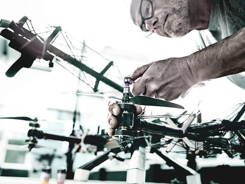 Person using Zyklop Quarter Inch Drive Socket With Holding Function For Screws on a drone propeller assembly.