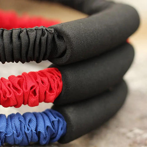 Close-up of red, blue, and black elastic bands showcasing Archery Bow Trainer Band For Draw Resistance And Strength Training, Adjustable 25 To 45 Lbs