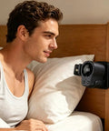 Man relaxing with Clip On Car Vent Fan With LED Display, 360 Degree Rotation, 199 Speed Settings mounted on headboard for cooling.