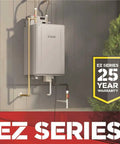 Mad Fast Instant Hot Water Flow Beige Natural Gas Tankless Water Heater mounted on wall with copper pipes and warranty sign.