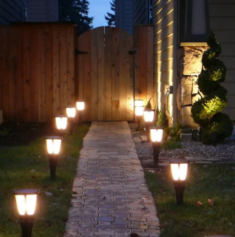 Low Voltage Landscape LED Light Bulb 12V T5 T10 Wedge Base Replacement used in garden pathway lighting, warm white glow.