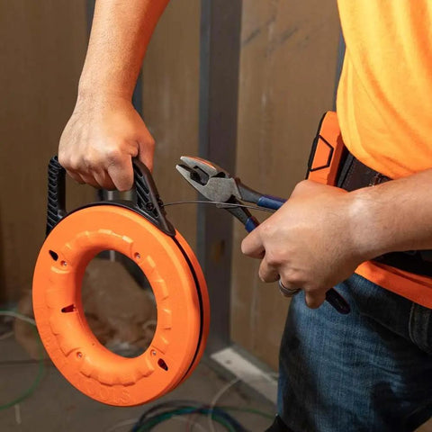 Top Shelf 13 Inch Flexible Fish Tape Leader For 1/8 Inch Steel Tapes shown in use with pliers, ideal for wiring tasks.