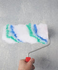 Person using Premium Mini Paint Roller Covers 24 Pack Polyester Sleeves For Wall Painting with colorful paint on wall.