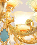 Next Level Modern Chandelier With Bold Adjustable Design And Sparkling Crystal Glass Accents Bright 15 Light Led Ceiling Pendant close-up of gold and blue accents.