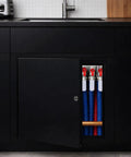 Heavy Duty Aluminum Access Panel For Drywall With Hinged Black Finish 12 By 12 Inch showing plumbing access behind black cabinet.