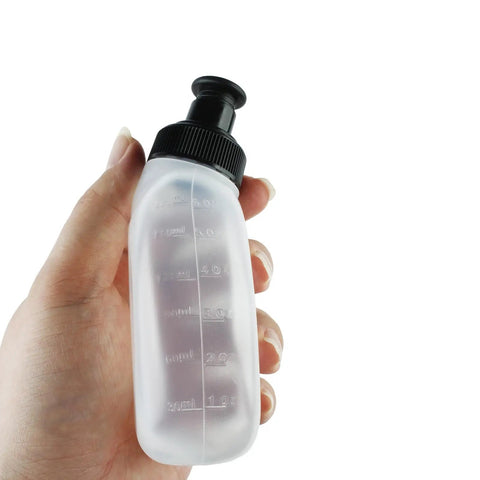 Hand holding a Two Pack 6oz Running Water Bottle For Hydration Belts And Waist Packs with black sip lid, durable plastic design