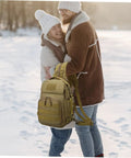 Couple in winter holding Camouflage Oxford Cloth Outdoor Fishing Backpack With Large Capacity Tactical Hiking Daypack For Men Women And Boys Tough Camping Gear Organizer For Trekking Travel And Everyday Adventures