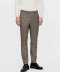 Man wearing brown plaid suit trousers and black dress shoes