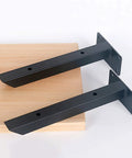 Rock Solid Wall Mounted Shelf Brackets Pack Of Two Heavy Duty Metal Supports Black Steel Finish 12 Inch Arms on wood plank.