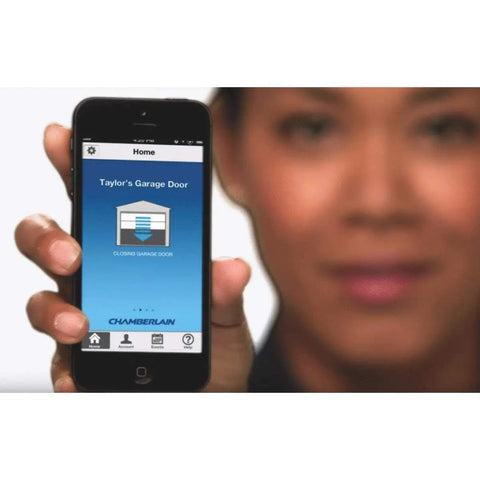 Person holding smartphone displaying app to Control Your Garage Door From Your Phone Anywhere Open It On The Go Monitor It And Get Real Time Alerts With The MyQ-Garage System Works With Most Openers Made After 1993.