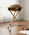 Heavy Duty Beech Wood Drum Rack With Tripod Legs And Adjustable Rope Mount For Steel Drums Folds Flat For Tour Ready Travel Hella Stable Pro Vibe With Thick Sponge Padding Large in a cozy room.