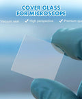 Gloved hand holding a square glass slide from 100 Count Square Cover Glass Microscope Slides Kit With Crystal Clear Glass For Top Notch Clarity And Universal Compatibility For Teachers Students Families And Science Enthusiasts