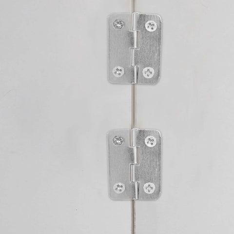 Close-up of 20 Piece Mini Hinge Set For DIY Projects And Handmade Crafts in silver iron, installed on a surface.