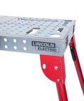Heavy Hitter Portable Welding Table Folding Workbench 21 X 44 Inches flat steel surface with red locking legs.