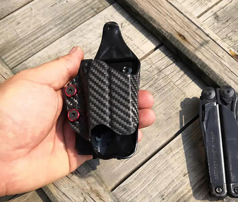 Top Shelf Chicago Screws And Stainless Steel 304 Holster Fasteners With Mixed Color Aluminum Spacers For Kydex Leather Belt Clips and Secure Outdoor Carry Hardware That Slaps, shown on a hand with a carbon fiber holster.