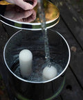 Filling water into gravity can with Ultra Sterasyl 7 Inch Ceramic Gravity Filter Cartridge 2 Pack in use