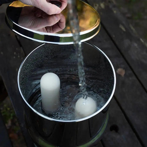 Filling water into gravity can with Ultra Sterasyl 7 Inch Ceramic Gravity Filter Cartridge 2 Pack in use
