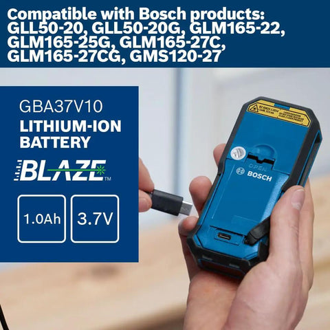 Hand inserting battery into Blaze Green Beam Laser Measure Up To 165 Feet With Real Time Distance Reading device.