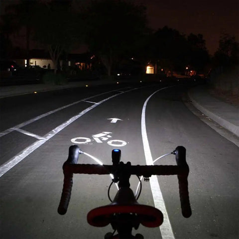 Cyclist perspective with Lumina 1000 Boost Front Bike Light With Sabre 110 illuminating bike lane at night
