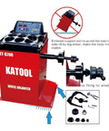 Industrial Grade Tire Changer And Wheel Balancer Combo With Two Horsepower Bead Blaster And Hardened Alloy Steel Jaws. Side view of red wheel balancer machine.