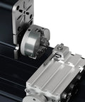 Front view of an all-metal miniature lathe with a large chuck and cross-slide on a black base.