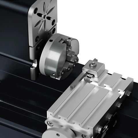 Front view of an all-metal miniature lathe with a large chuck and cross-slide on a black base.