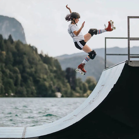 Skater performing jump on ramp, using Rock Solids Roller Skate Bearings 16 Pack For Quad Skates ABEC 9 Pro Grade 8mm