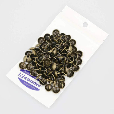 Top Shelf 100 Piece Set Of Antique Bronze Upholstery Nails And Decorative Furniture Tacks displayed in a package.