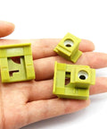 Hand holding 2 Pack Beefed Up Transmission Shift Cable Bushing Clip Kit Yellow For Ford Vans And SUVs Gearbox Shifter Linkage Fix Bushing Clamps Replacement Cable Column Shift Linkage Clips
