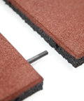 Close-up of interlocked outdoor rubber tiles 20x20 inch 1 inch thick showing connectors for playground and backyard gym flooring.