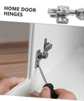 Two stainless steel cabinet door hinges with hydraulic buffer, installed on white kitchen cabinet.