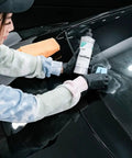 CeriGlass Glass Polish And Cleaner Compound For Auto Glass Restoration 500ml 17oz Removes Swirls Light Scratches Water Spots Tiny Pits And Wiper Grime With Dual Action Machine For Crystal Clear Windshield. Technician polishing black car windshield with 500ml bottle and pad
