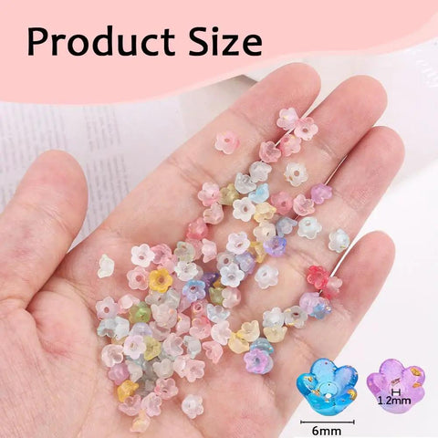 Hand holding Acrylic Frosted Flower Beads Six Millimeter With Golden Speckles Matte Mini Floral Spacer Beads Bulk 1000pcs for DIY crafts