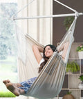 Woman relaxing in XXL Hammock Chair For Big Folks With Generous 70.9 By 47.2 Inches, 500 Lb Capacity, Heavy Duty Steel Spreader Bar indoors