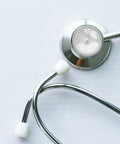 Angled front view of a stethoscope with silver chest piece and white ear tips