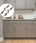 Leaf Shape Drawer Pull Handle Set In Vintage Bronze Finish installed on gray kitchen cabinets, showcasing twig branch design.