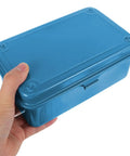 Hand holding a blue Kickass Vintage Iron Tool Box With Secure Locking Lid And Snappy Quick Access Compartments For Home Mechanic And Car Garage Heavy Duty Metal Storage Solution.