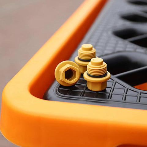 Close-up of Heavy Duty Spill Proof Oil Tank Containment Tray Set For Warehouses And Shops with yellow drain plugs on black surface.