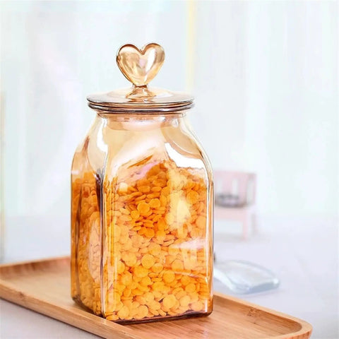 Top Shelf Durable Borosilicate Glass Jar Slick Amber Tint Secure Flip Lid Seal Keep Your Coffee Beans Spices And Dried Fruit Fresh In Style No Sweat Kitchen Pantry Organization Solution That Goes Hard with heart-shaped lid and orange cereal.