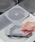 Heavy Duty Two Pack Square Hair Drain Catcher And Tub Filter With Grip Tight Suction Pads To Keep Your Shower Bathtub And Kitchen Sink Totally Clear Grey in sink, showing mesh design and suction pad grip.