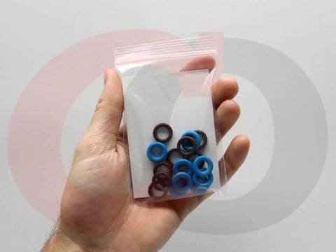 Hand holding Fuel Injector O Ring Seal Kit 217-1588 Replacement For GM Vehicles, clear bag showing 16 blue and brown seals