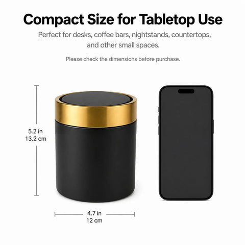 Mini Desktop Trash Can With Swing Lid Sleek Black And Brushed Gold Rim 1.5 Liter Capacity Compact beside smartphone for scale