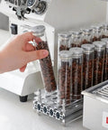 Single Dose Coffee Bean Storage Tubes, Glass And Aluminum Vials, clear tubes with coffee beans on acrylic organizer.
