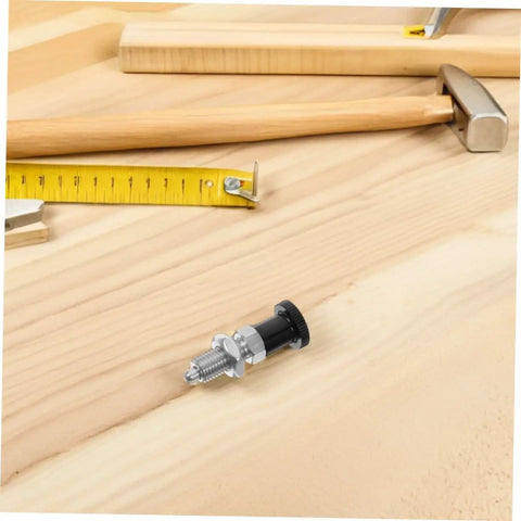 Built Tough Indexing Plunger Pin With Dead Tight Spring Loaded Threaded Design In Premium Stainless Steel for quick fix jobs on a wooden surface.
