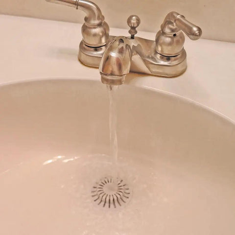 White Two Pack Bathroom Sink Hair Catcher With Heavy Duty Suction Cup For Pop Up Drains And One Inch Stopper in use with water flowing.