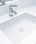 4pcs Rubber Sink Drain Stopper with Pull Ring for Bathtubs installed in a modern white bathroom sink with chrome faucet.