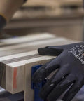 Person wearing Nitrile Coated Work Glove With MicroFoam Grip Palm And Fingers Delivers Next Level Grip And Abrasion Resistance While Keeping 360 Degree Breathability So You Can Handle Food Or Heavy Duty Jobs All Day FDA 21 CFR Part 186 Compliant, handling wood