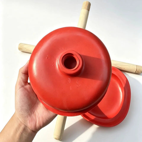 Rock Solid Heavy Duty Rubber Cup Toilet Plunger With Reinforced Wooden Handle, red rubber cup held in hand.