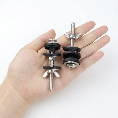 Hand holding 2 Pcs Toilet Tank Bolts Replacement Kit Heavy Duty Stainless Steel Universal Toilet Seat Bolts And Nuts With Rubber Washers
